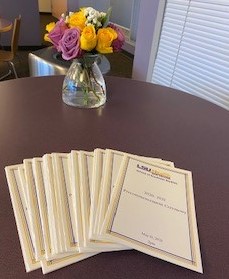 Picture of flowers and precommencement programs on a table