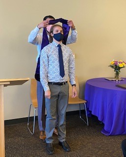 image of Dr. Zachary Stielper receiving his PhD hood from his mentor, Dr. Nicholas Gilpin